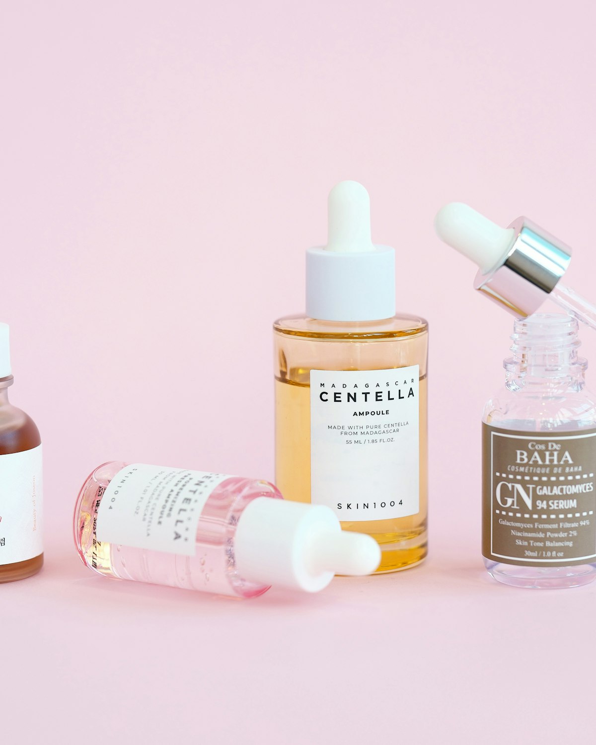 Korean skincare ampoules on pink